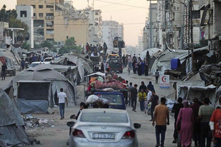 Displaced Palestinians fleeing the northern Gaza Strip on a street in Gaza City, Friday, Aug. 29, 2025. 