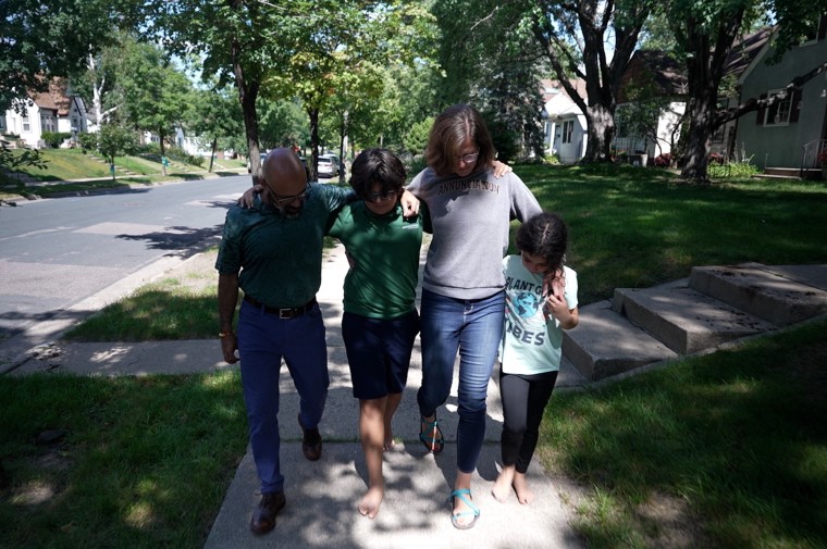 Image: The Maldonado family walk down the street in their neighborhood.
