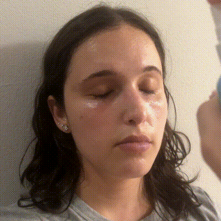 Gif of woman spraying Cocokind face mist on face