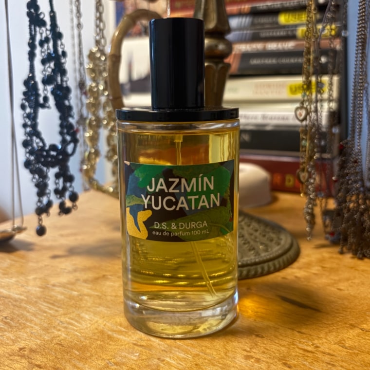 Bottle of perfume on a dresser.