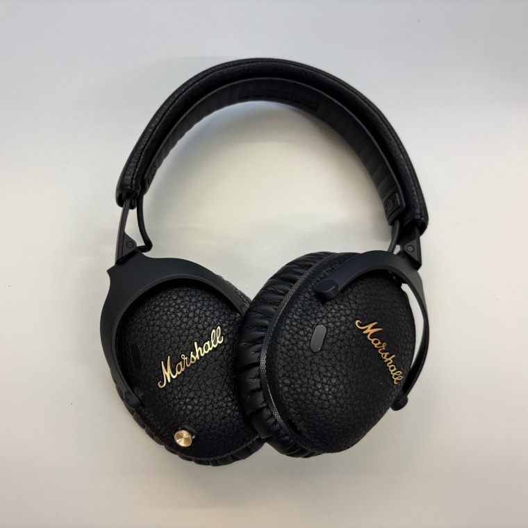 Marshall Monitor III headphones sitting on a table.