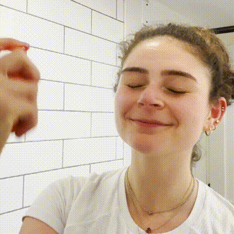 Gif of woman spraying Tower 28 hypochlorous acid spray on face