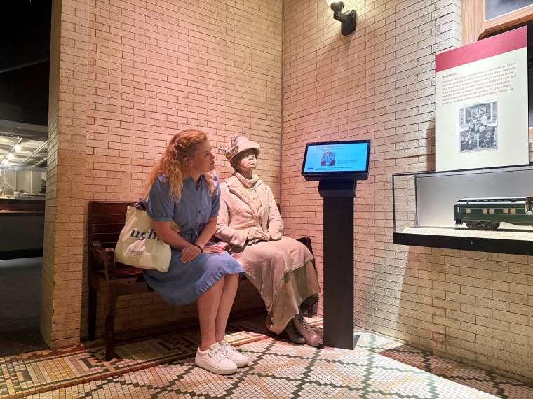Kathryn Jones reads a plaque about Charlotte Hawkins Brown, an author, educator, and civil rights activist.