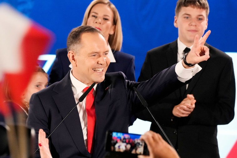 Nawrocki greets supporters at his headquarters after the presidential election runoff in Warsaw in June. 