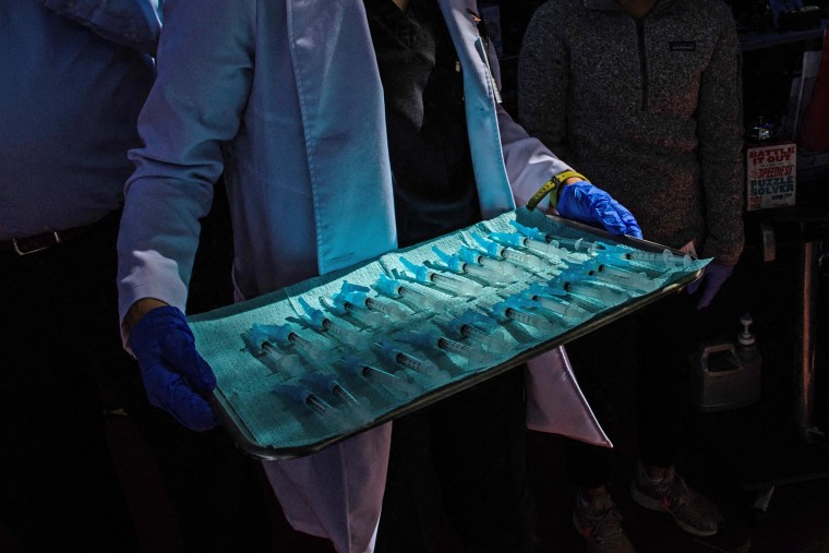 A medical assistant transports the Moderna Covid-19 vaccine ready to be administered at a vaccination site at Kedren Community Health Center, in South Central Los Angeles on Feb. 16, 2021.