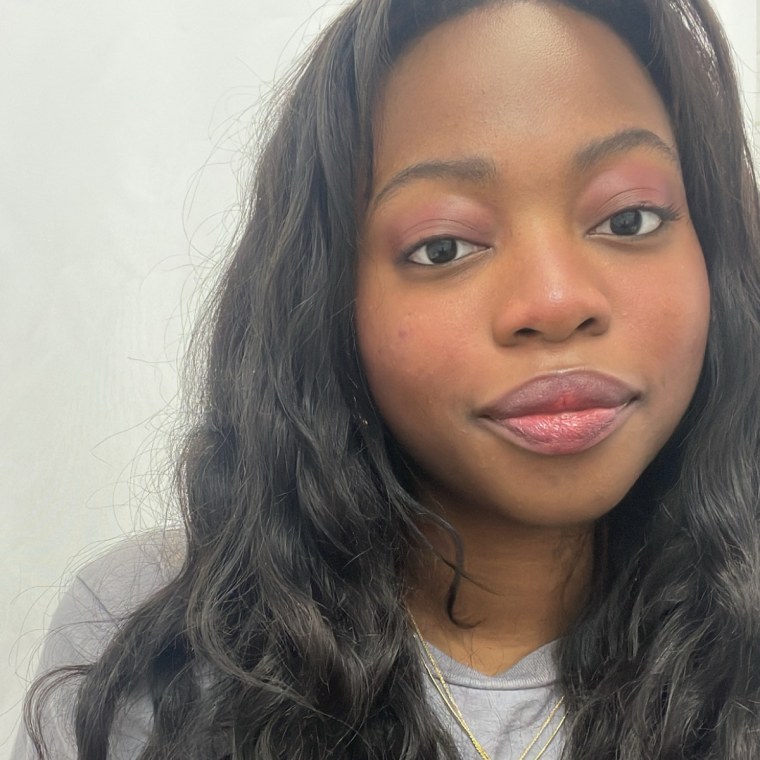 A photo of a woman with a plum shade of makeup on her eyelids, cheeks, and lips.