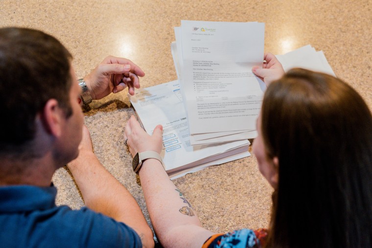 Nick and Misty sort through papers on a counter top
