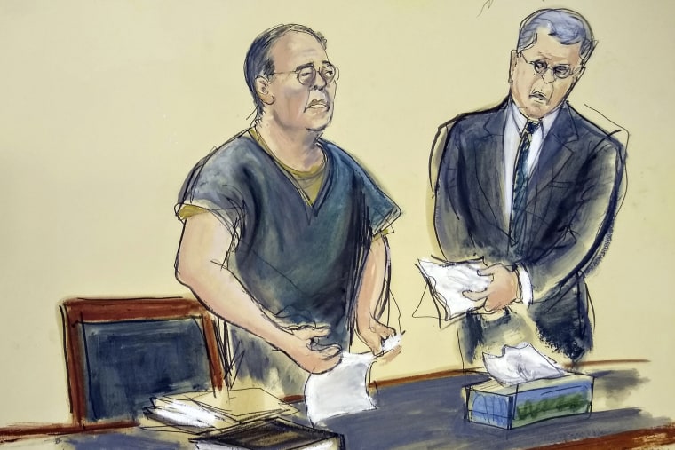 Former Hong Kong Home Affairs Secretary Patrick Ho makes a statement to the judge as Benjamin Rosenberg, his attorney, hands him a tissue at his sentencing in New York on March 25, 2019.