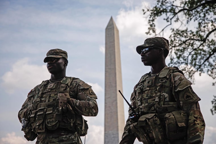 Members of the D.C. National Guard stand in front of the Washington Monument on Aug.17, 2025.
