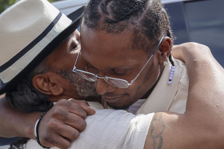 Bryan Hooper Sr. embraces his son Bryan Hooper Jr.