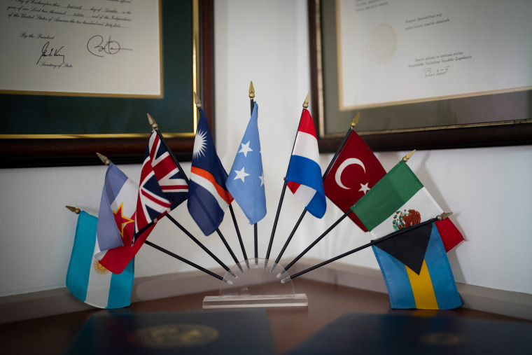 Flags of various countries displayed on a table top