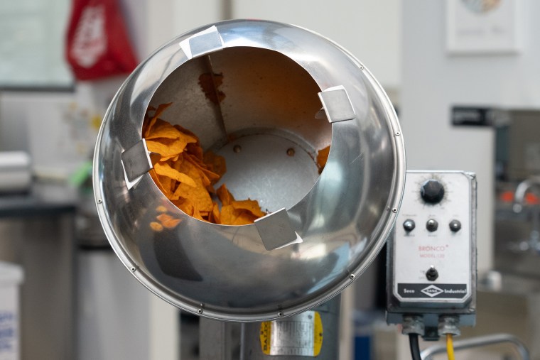 Nacho food seasoning made from earthy dyes is added to Doritos.