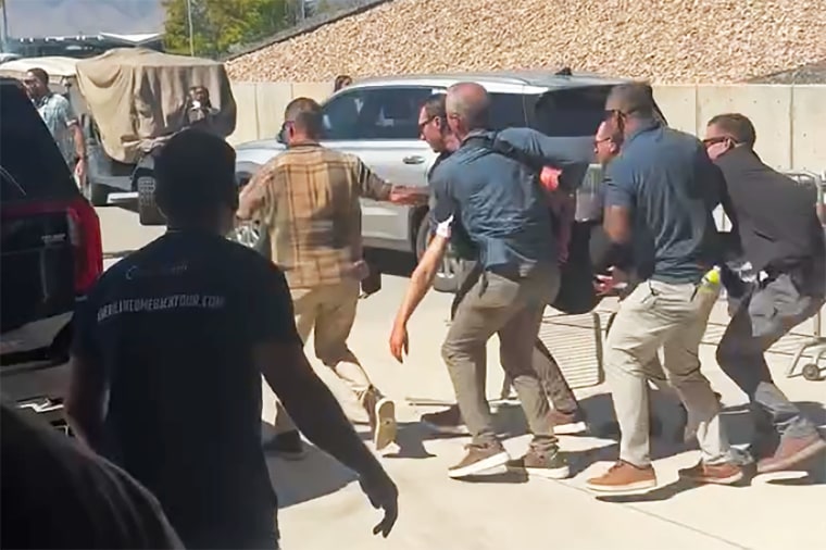 Kirk is carried from the scene yesterday.