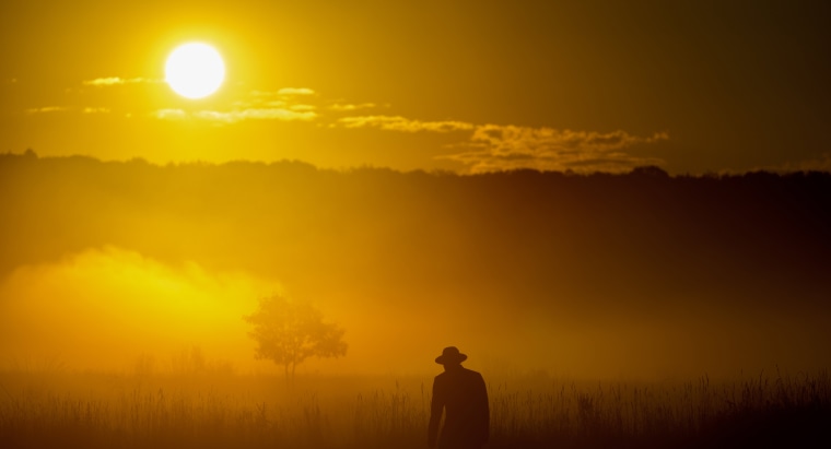 Sunrise silhouettes a park ranger at the Flight 93 National Memorial on Sept. 11, 2025 in Shanksville, Pa.