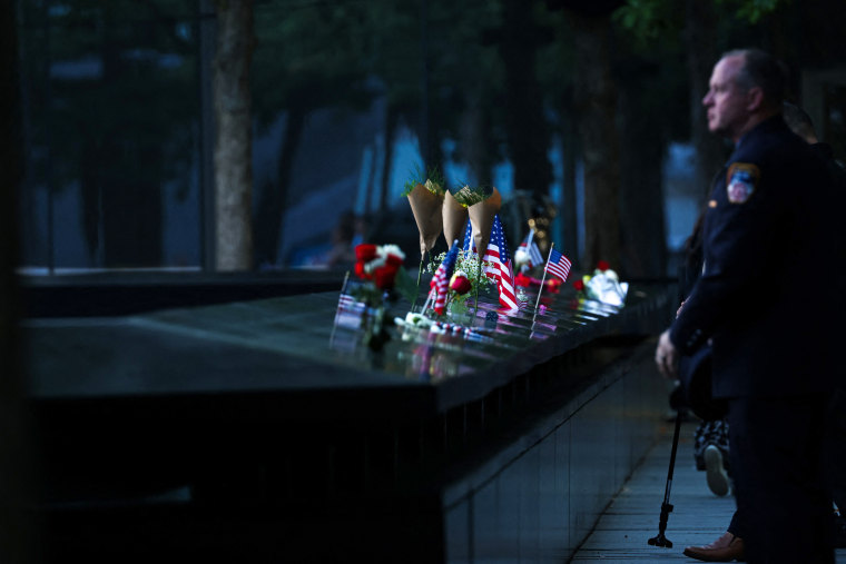 People pay tribute at the South Tower reflecting pool at the 9/11 Memorial and Museum at the World Trade Center complex, before the 9/11 commemoration ceremonies at Ground Zero in New York on September 11, 2025.