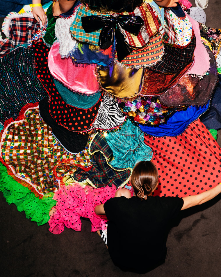 A person fixes a dress.