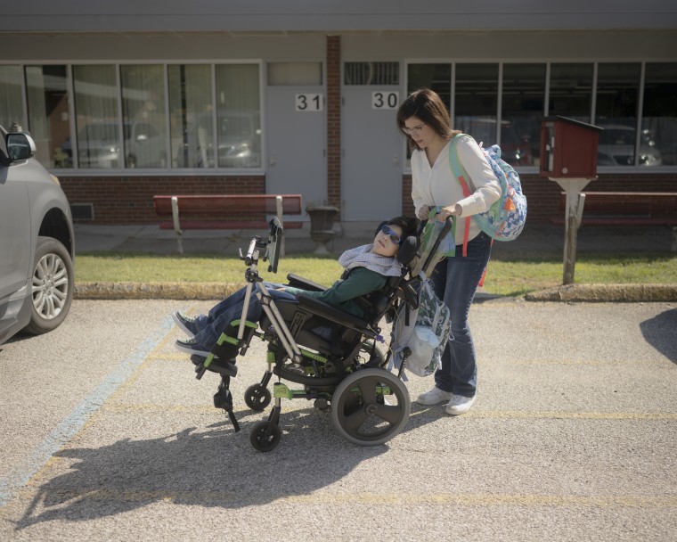 Maxwell Jackson with his mother, Marisa Jackson, at his public elementary school. “I think that's critical for his development, to be around other children his age and to be in that environment,” Marisa said.  