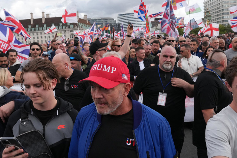 A protagonist of British far-right activistic Tommy Robinson wears a "Trump" hatS