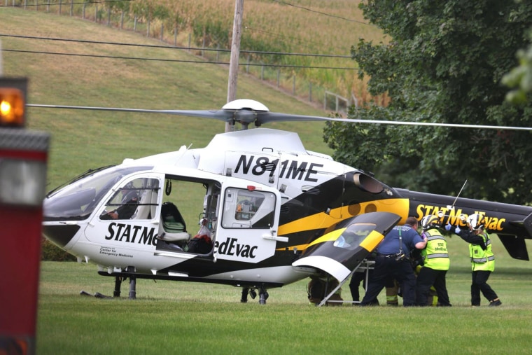 An officer is loaded into a helicopter