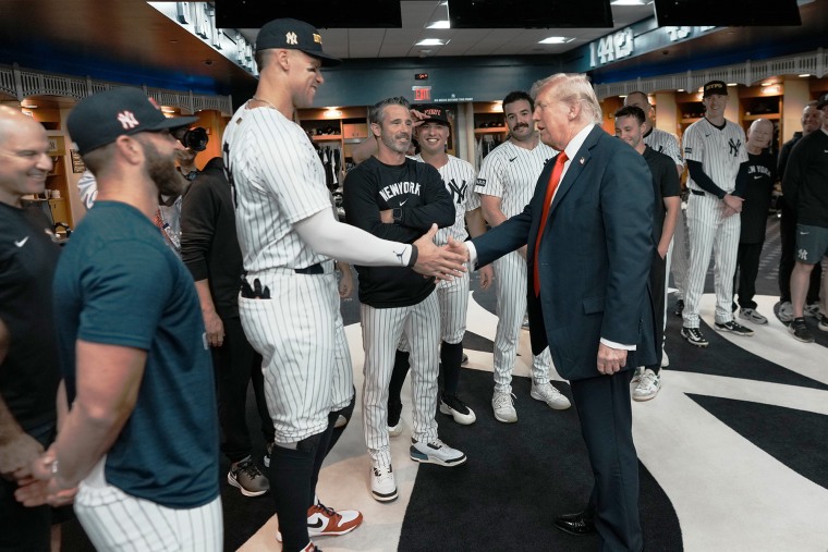 President Donald Trump shakes hands with Aaron Judge of the New York Yankees in the locker room before a game against the Detroit Tigers at Yankee Stadium on September 11, 2025 in New York City.