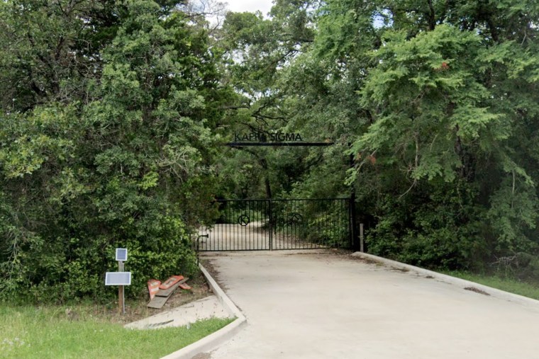 An entrance gate near a forested area