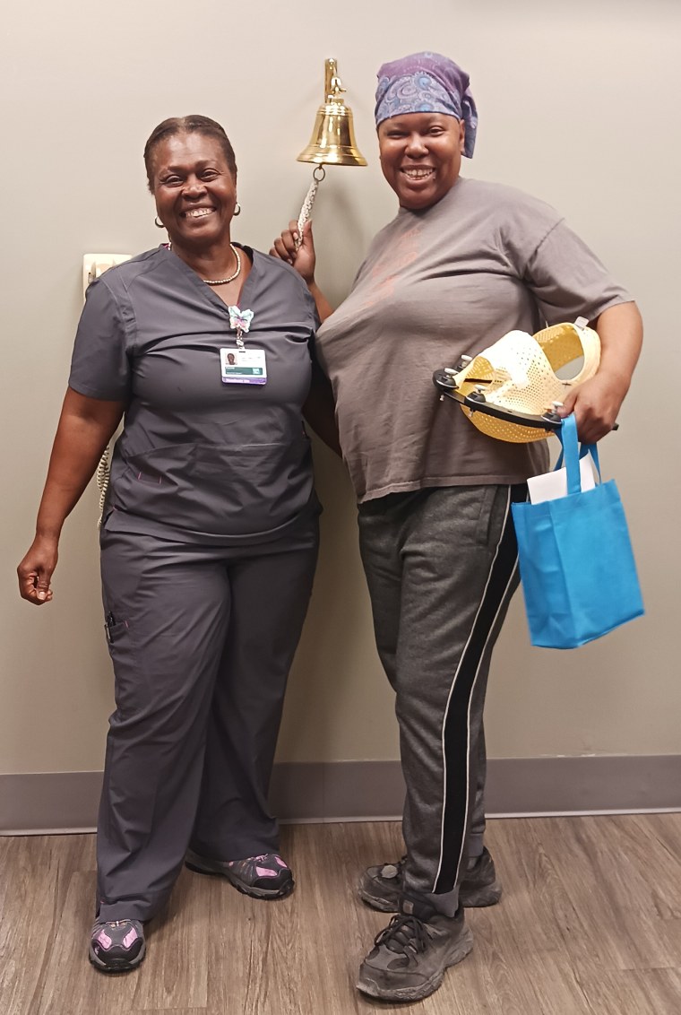 Phillip, right, rings the bell on her last day of radiation treatment on March 25, 2024.