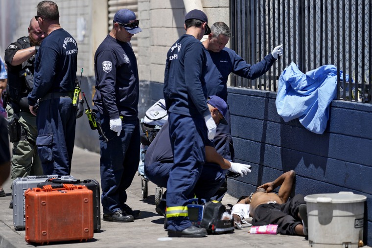 Os bombeiros de Phoenix tratam um sem-teto durante a onda de calor em 30 de maio de 2024 em Phoenix.