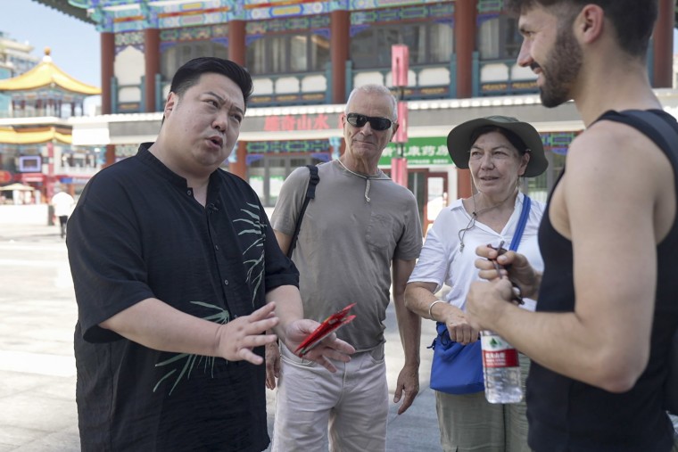 Chen interacting with tourists in Chongqing.