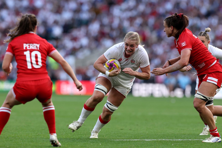 Alex Matthews of England charges at Taylor Perry and Caroline Crossley of Canada during the Women's Rugby World Cup 2025 Final on Sept. 27, 2025 in London.