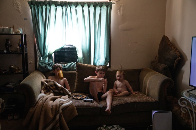 Melinda Johnson's twin boys Cash and Cole watch TV with her daughter Memphis.