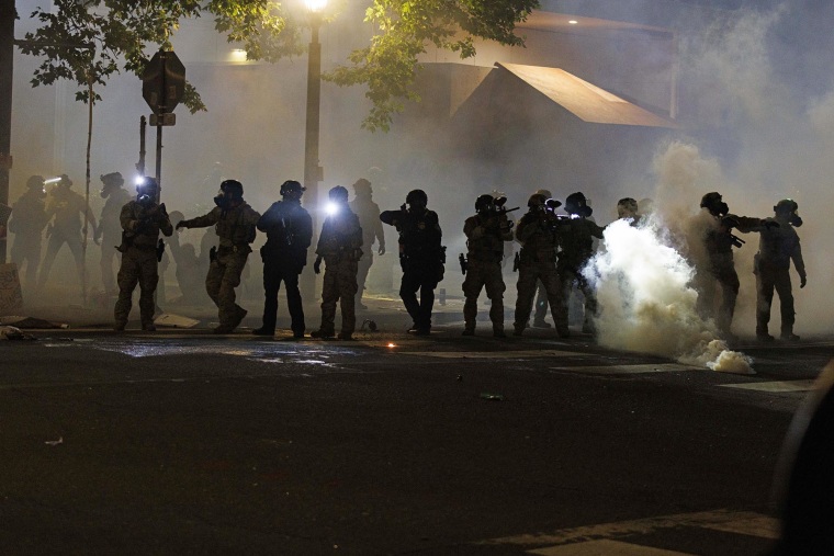Tear gas fills the air as law enforcement responds to protesters at the ICE facility in Portland