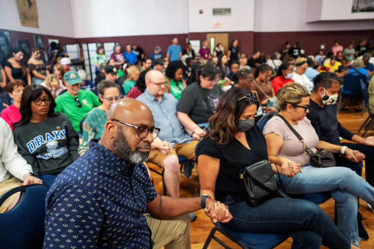 Community members holding hands during a church service