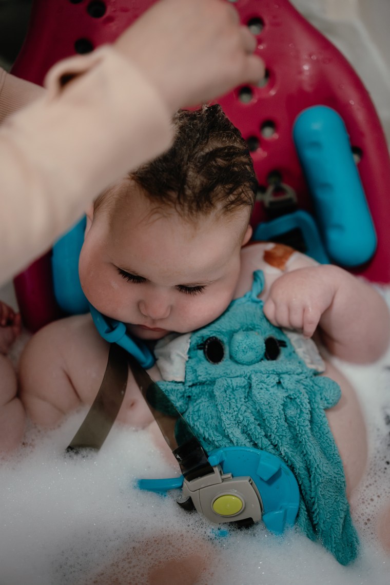 Carrie Lazoen bathes her daughter in a special bath chair.