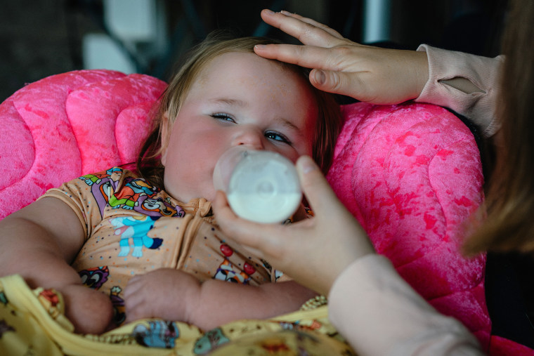 Carrie Lazoen gives Emmy a bottle.