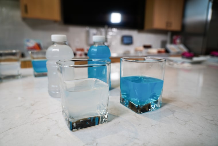 Two drinks in glasses on a counter