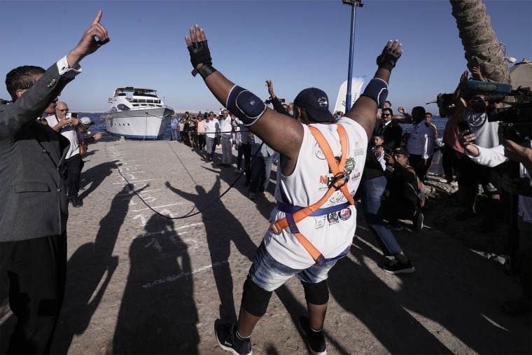 Egyptian wrestler Ashraf Mahrous, better known as Kabonga, pulls a 700-ton ship across the water with a rope held only by his teeth at the marina of the Red Sea resort of Hurghada, Egypt, on Saturday, Sept. 27, 2025. 