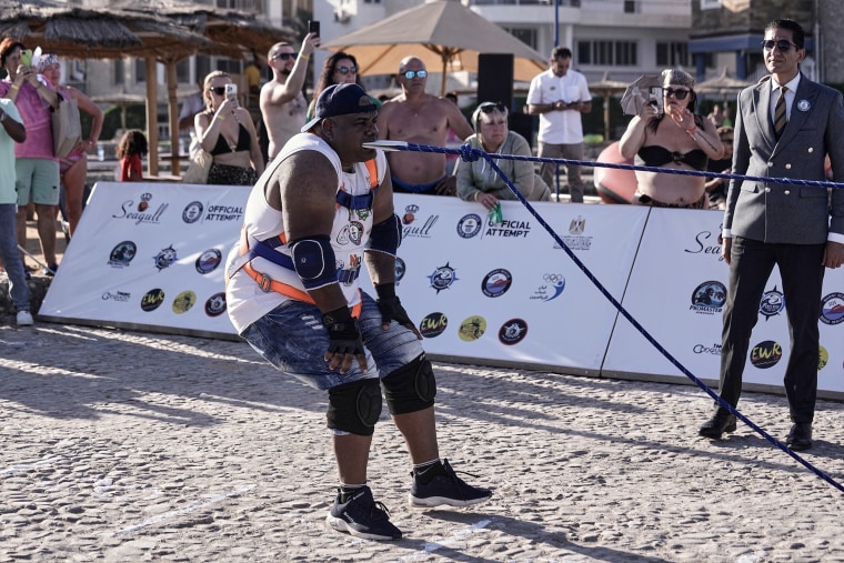 Egyptian wrestler Ashraf Mahrous, better known as Kabonga, pulls a 700-ton ship across the water with a rope held only by his teeth at the marina of the Red Sea resort of Hurghada, Egypt, Saturday, Sept. 27, 2025.