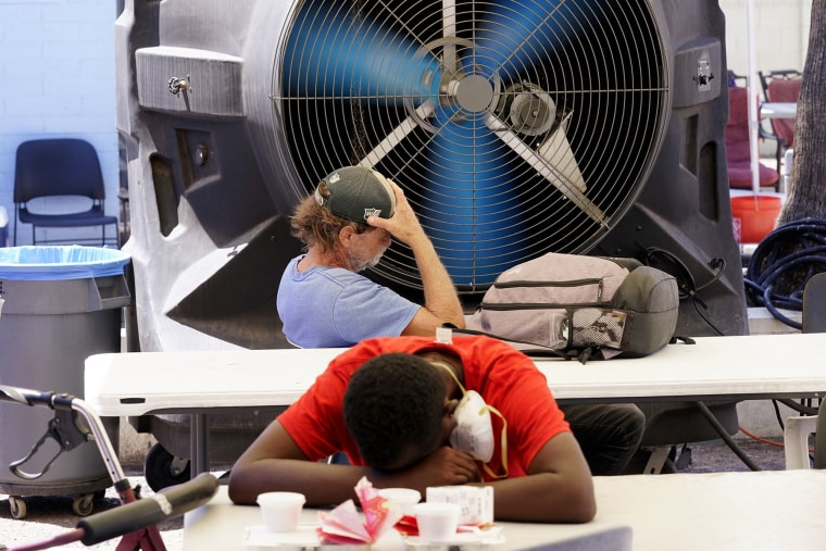 Homeless people try to keep cool down at the Justa Center in Phoenix.