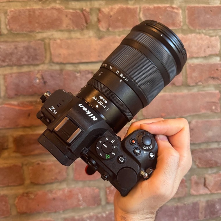 The Nikon Z5II with the Nikkor 24-120mm f/4 S lens attached against a brick wall background.