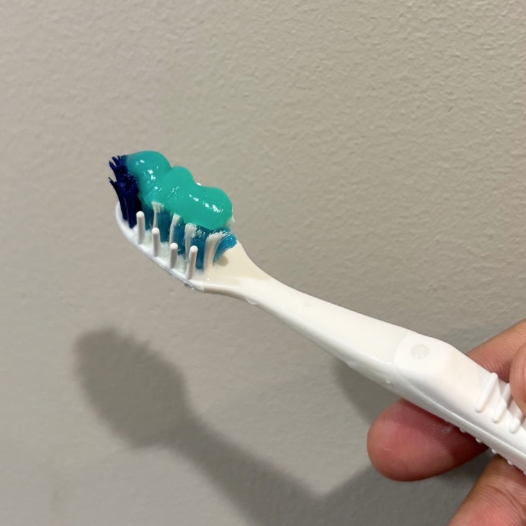 OpalescenceTeeth Whitening Toothpaste on a toothbrush.