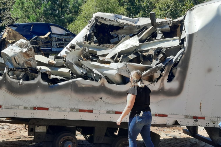 Sabrina Taylor in front of the wreckage
