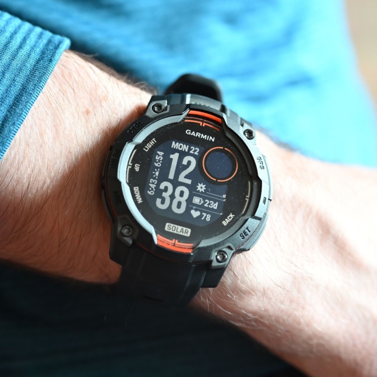 A close-up of the Garmin Instinct 3 Solar on the wrist of the writer.