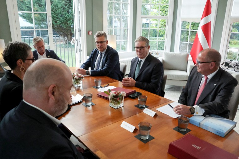 EU leaders sit at a table indoors