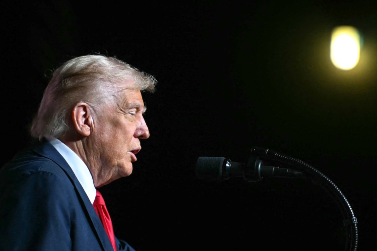 U.S. President Donald Trump speaks at a microphone.