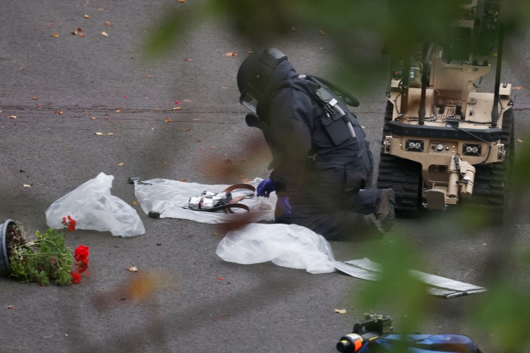 Police officers work at the scene following an incident outside a synagogue, in Manchester