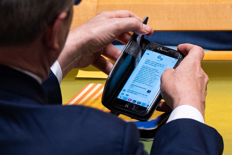 Treasury Secretary Scott Bessent checks a text message regarding Argentina relations with the U.S. during the United Nations General Assembly on Sept. 23, 2025.