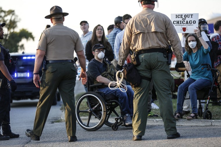 Image: Local and state law enforcement stand guard