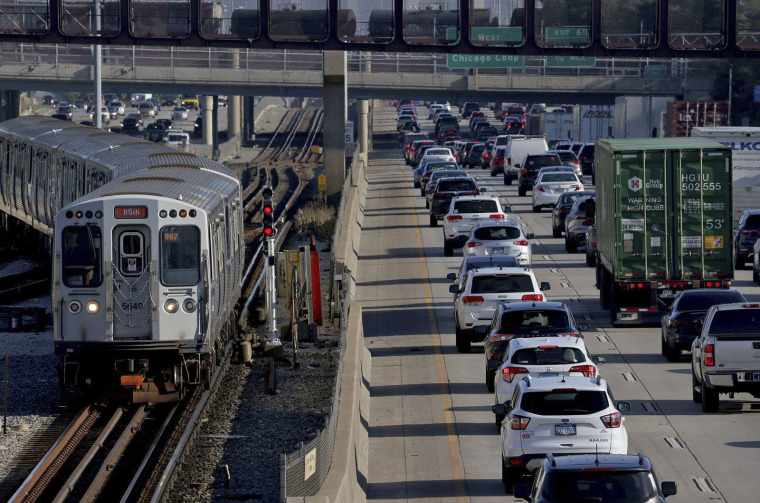 A CTA Red Line train approaches the 95th Street station as heavy traffic travels along the Dan Ryan Expressway toward the Loop on Aug. 30, 2022. 