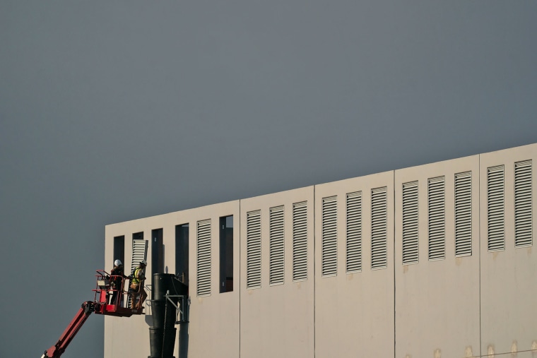 Construction crews work at the site of a planned Digital Realty data center in Manassas, Va., on July 9, 2025.