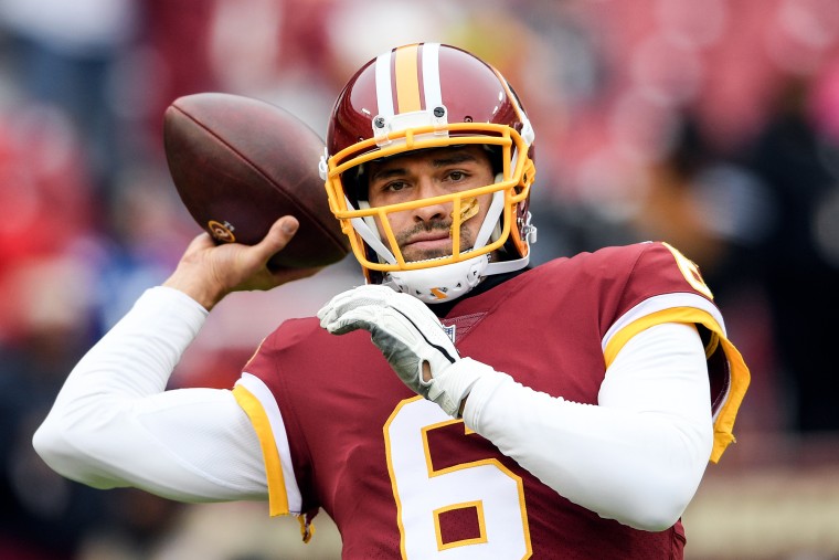 Mark Sanchez prepares to throw a football